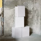 White cardboard box PSD mockup. The boxes are piled up on top of each other on a concrete floor in an industrial space. Wine packaging mockup. Wine shop mockup.