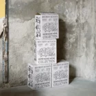 White cardboard box PSD mockup. The boxes are piled up on top of each other on a concrete floor in an industrial space. Wine packaging mockup. Wine shop mockup.
