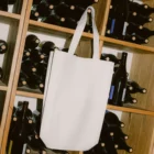 White tote bag PSD mockup. Tote bag mockup surrounded by wine bottles and cardboard boxes. Wine merchandising mockup. Restaurant mockup. Wine bar mockup. Fashion and apparel mockup.