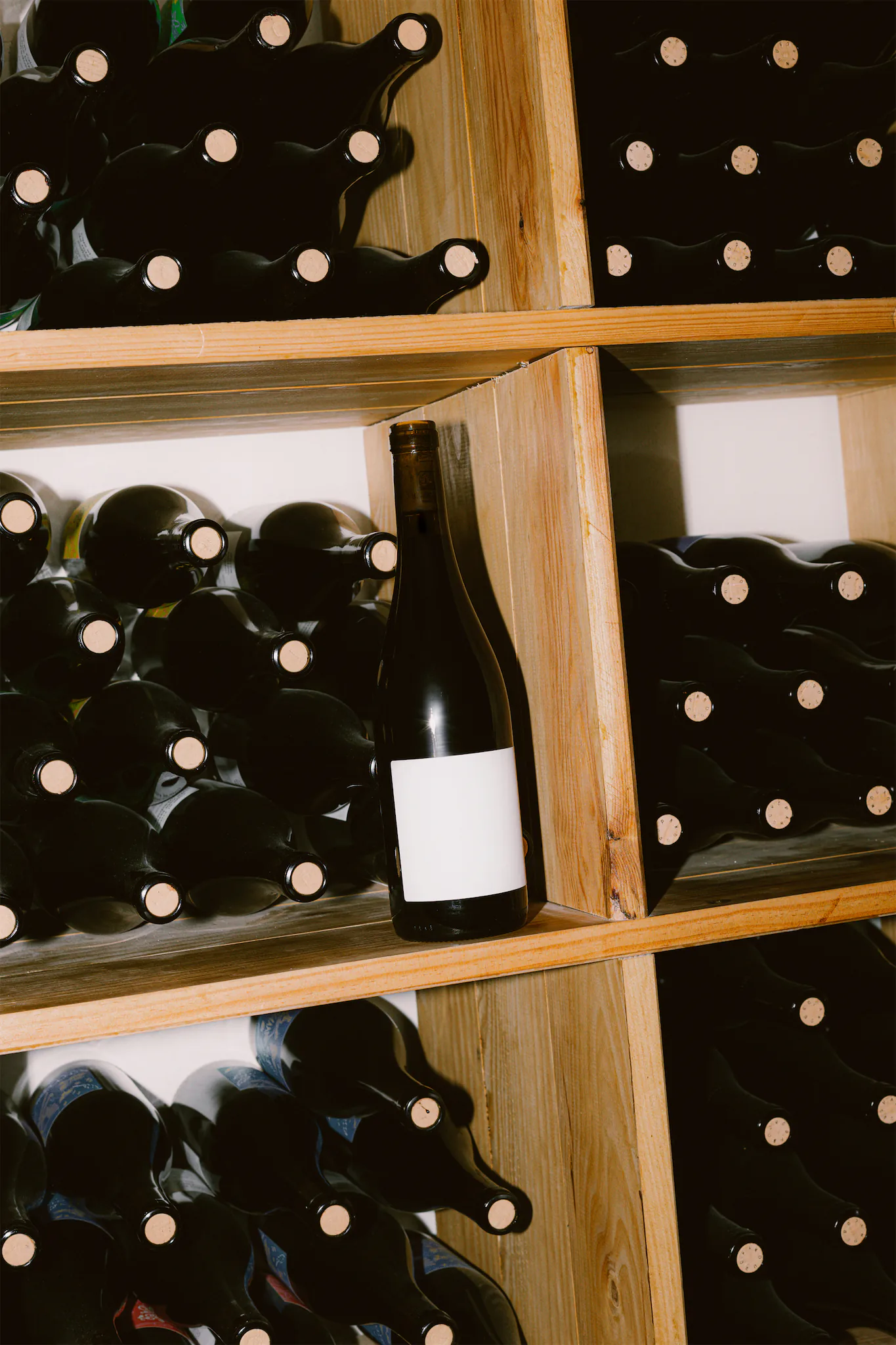 Wine label PSD mockup. Wine bottle mockup resting on a wine cellar shelf