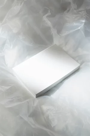 Book format mockup on top of a transparent plastic with a ray of light. Editorial mockup.