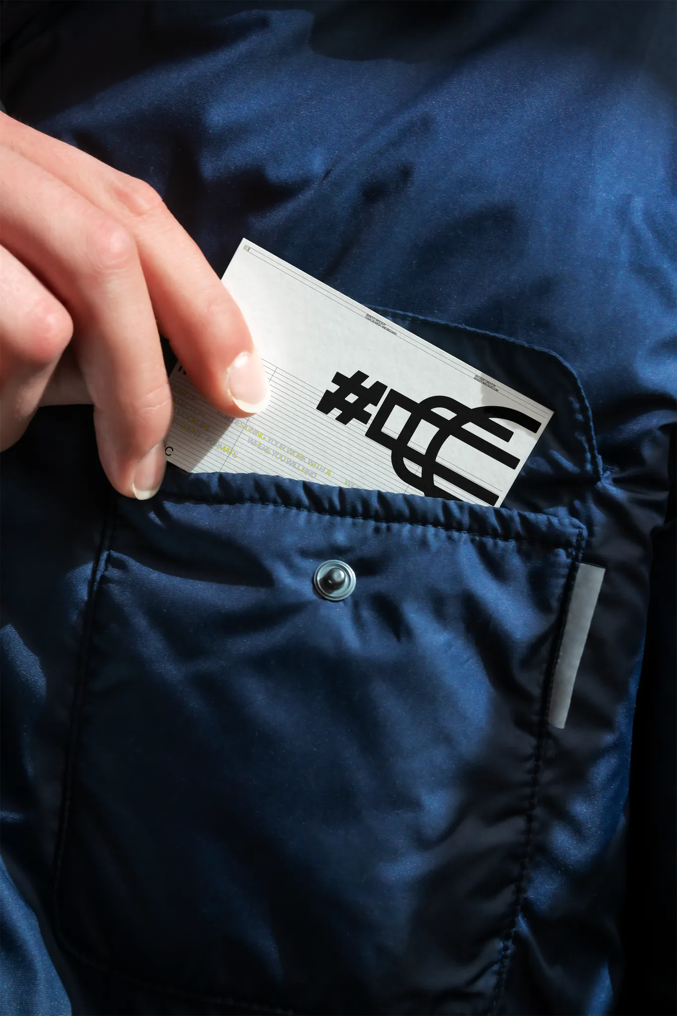 Business card mockup of a man taking out a business card of his jacket pocket. Branding mockup.