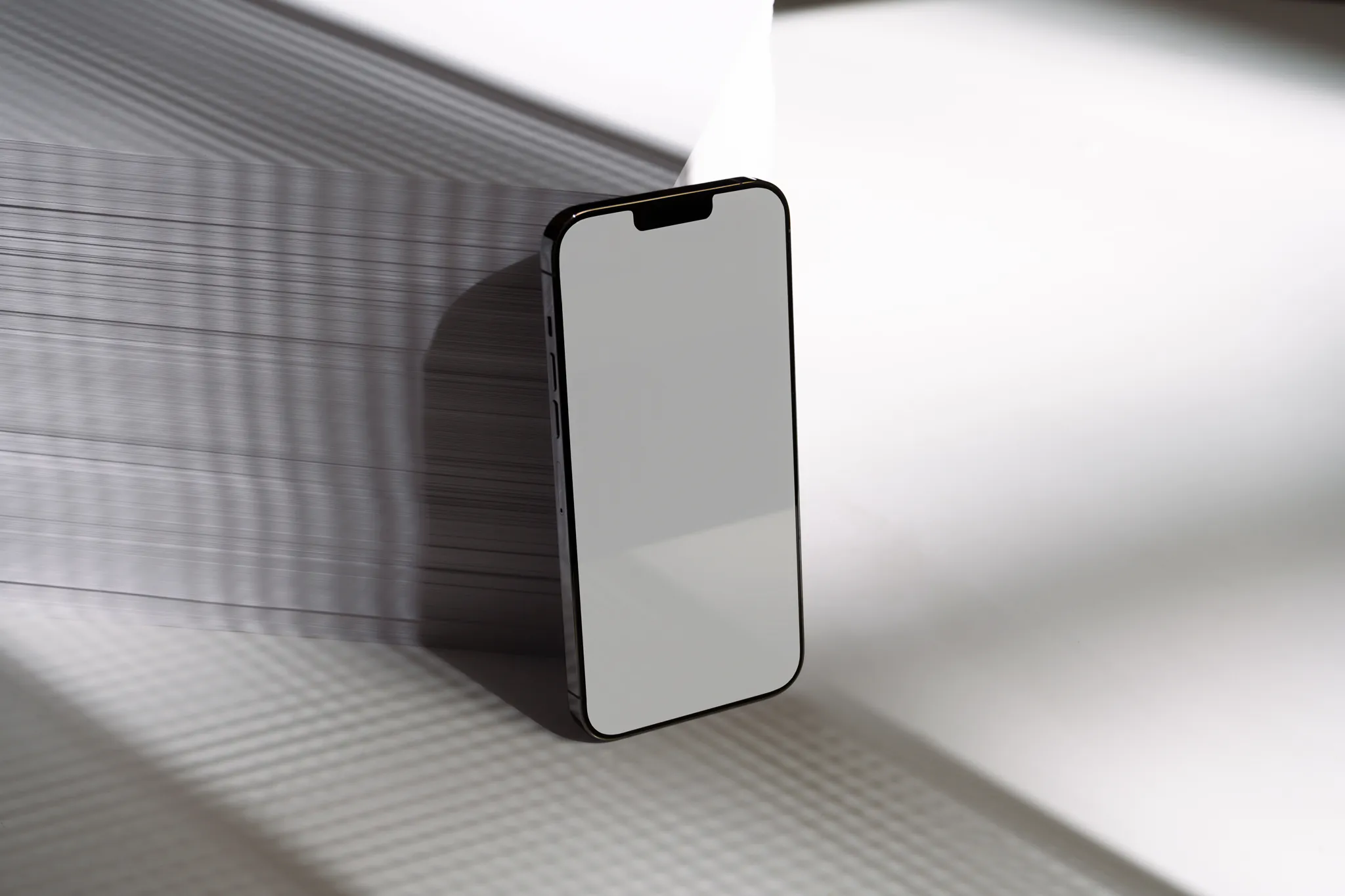 iPhone mockup. iPhone leaning against a block of A4 Format. Tech mockup.