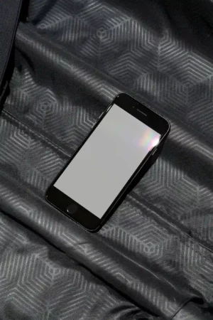 iPhone mockup over a patterned grey surface. Tech mockup.
