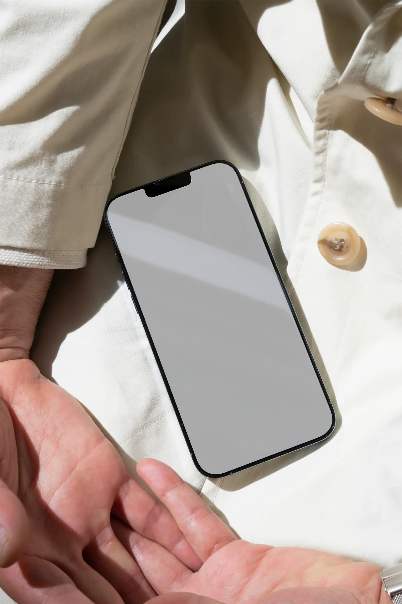 iPhone PSD mockup. iPhone on top of the white coat of a man. Tech mockup.