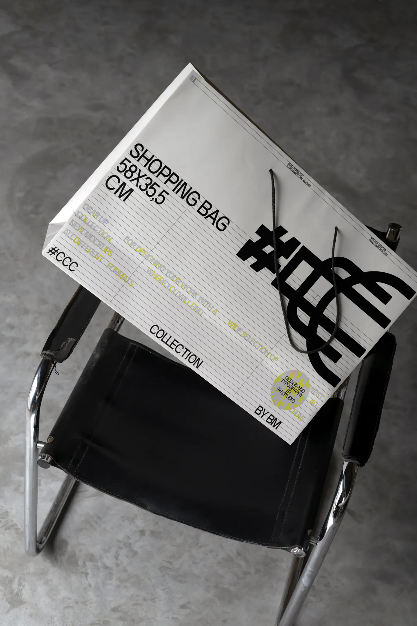 Shopping bag PSD mockup on a black leather chair in an industrial scene. Branding mockup.