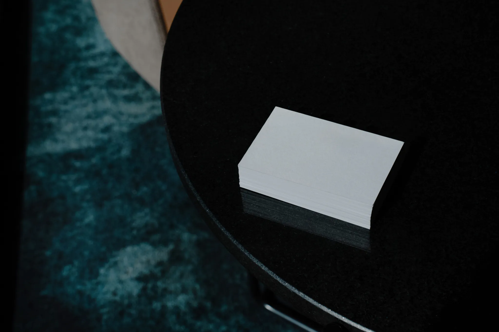 Block of business cards mockup on top of a black marble table. Branding mockup.