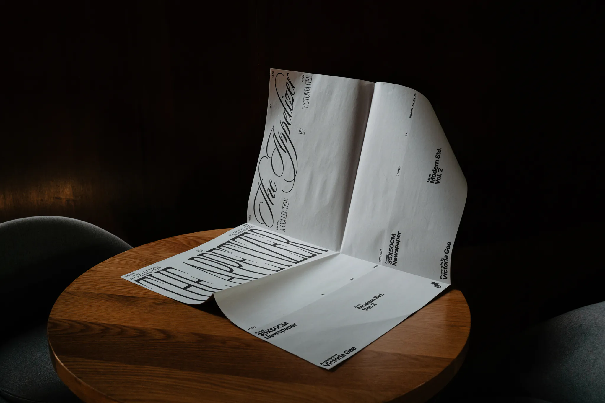 PSD mockup of a newspaper which is open placed on an elegant black marble table. Editorial mockup.