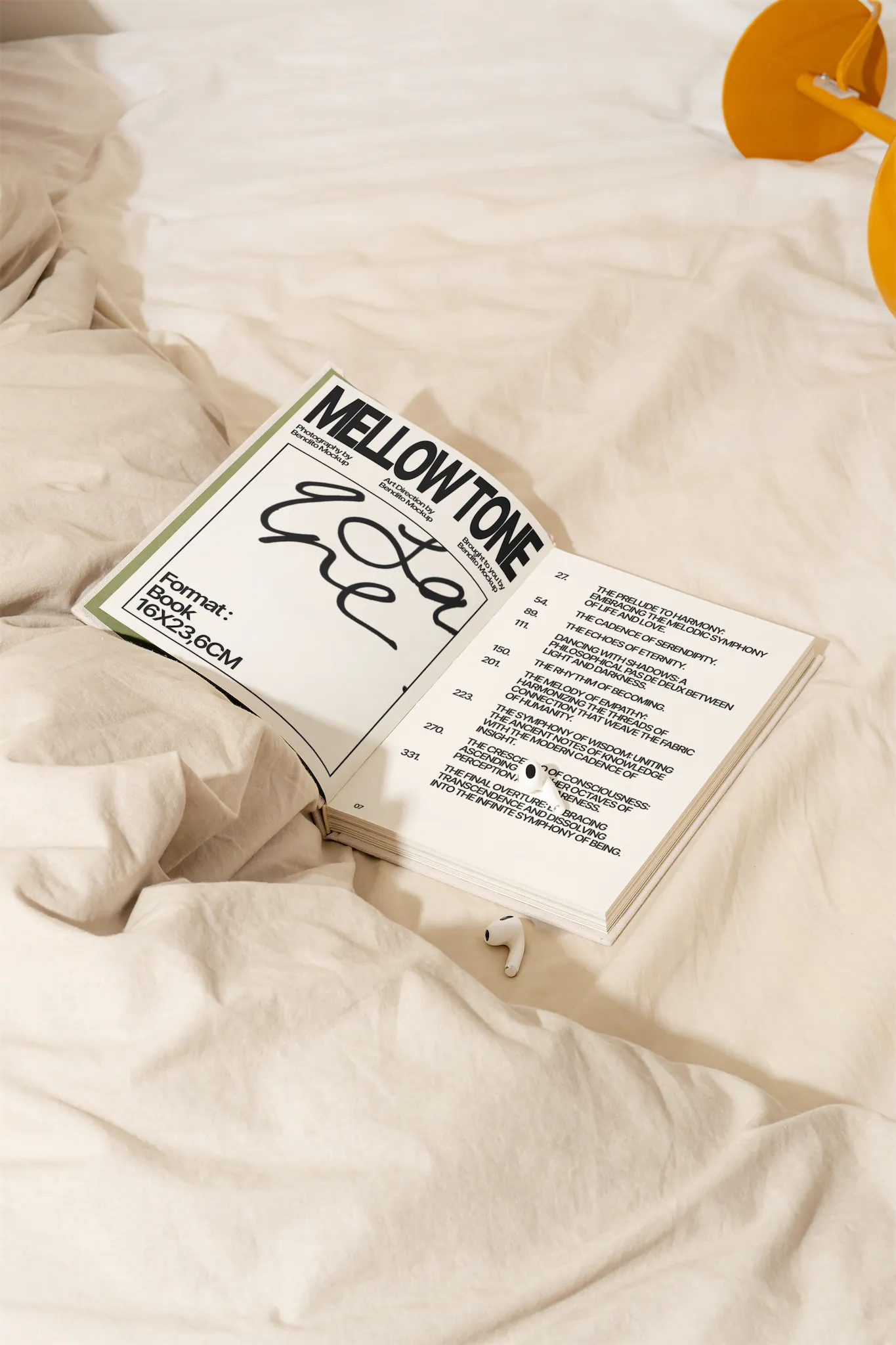 Hard cover book mockup laying on top of an unmade bed. High-quality open book mockup laying on top of white sheets. Premium book mockup placed in a beautiful house interior.