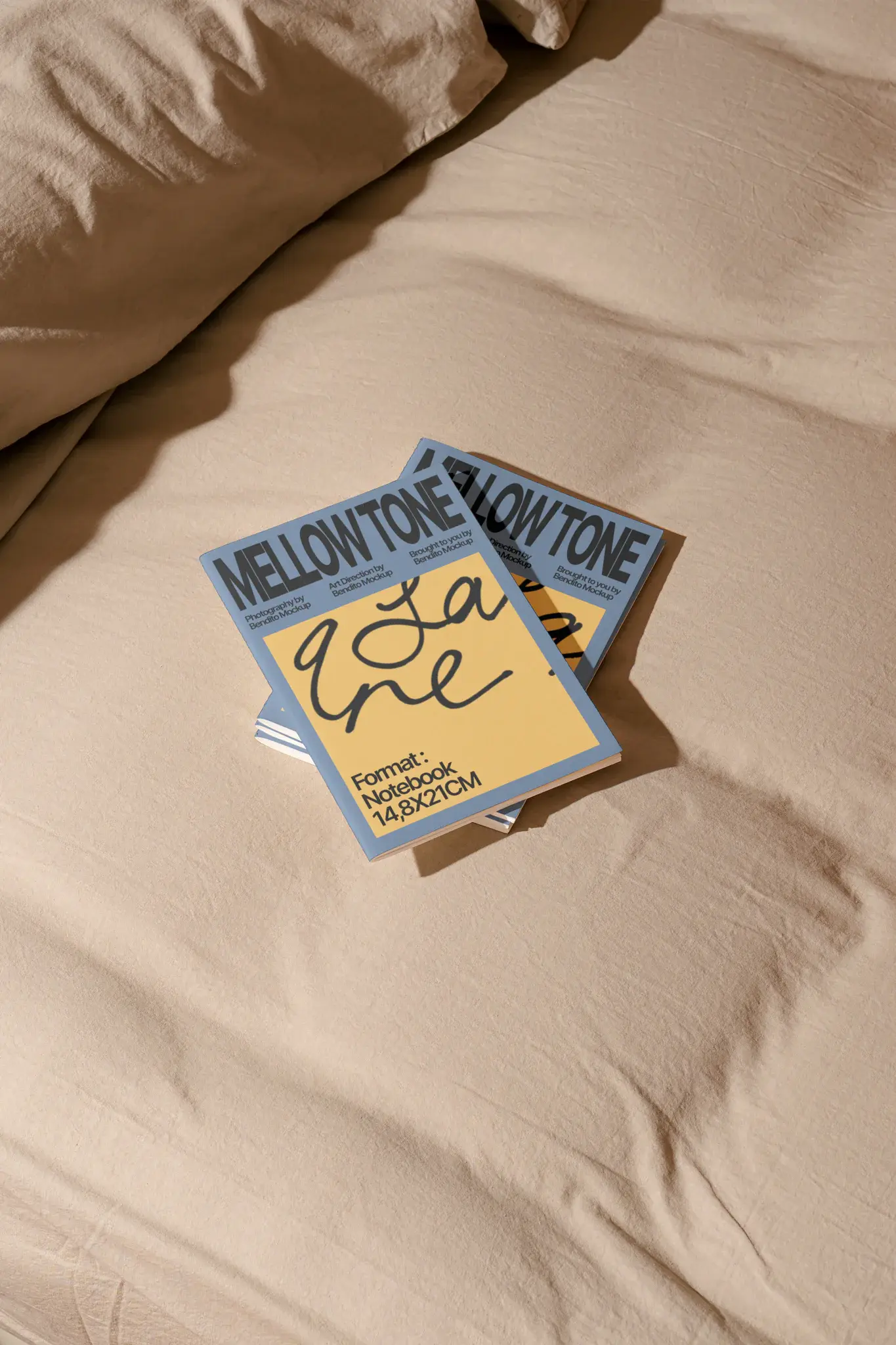 elegant style. Premium notebook mockup resting on the sheets of an unmade bed