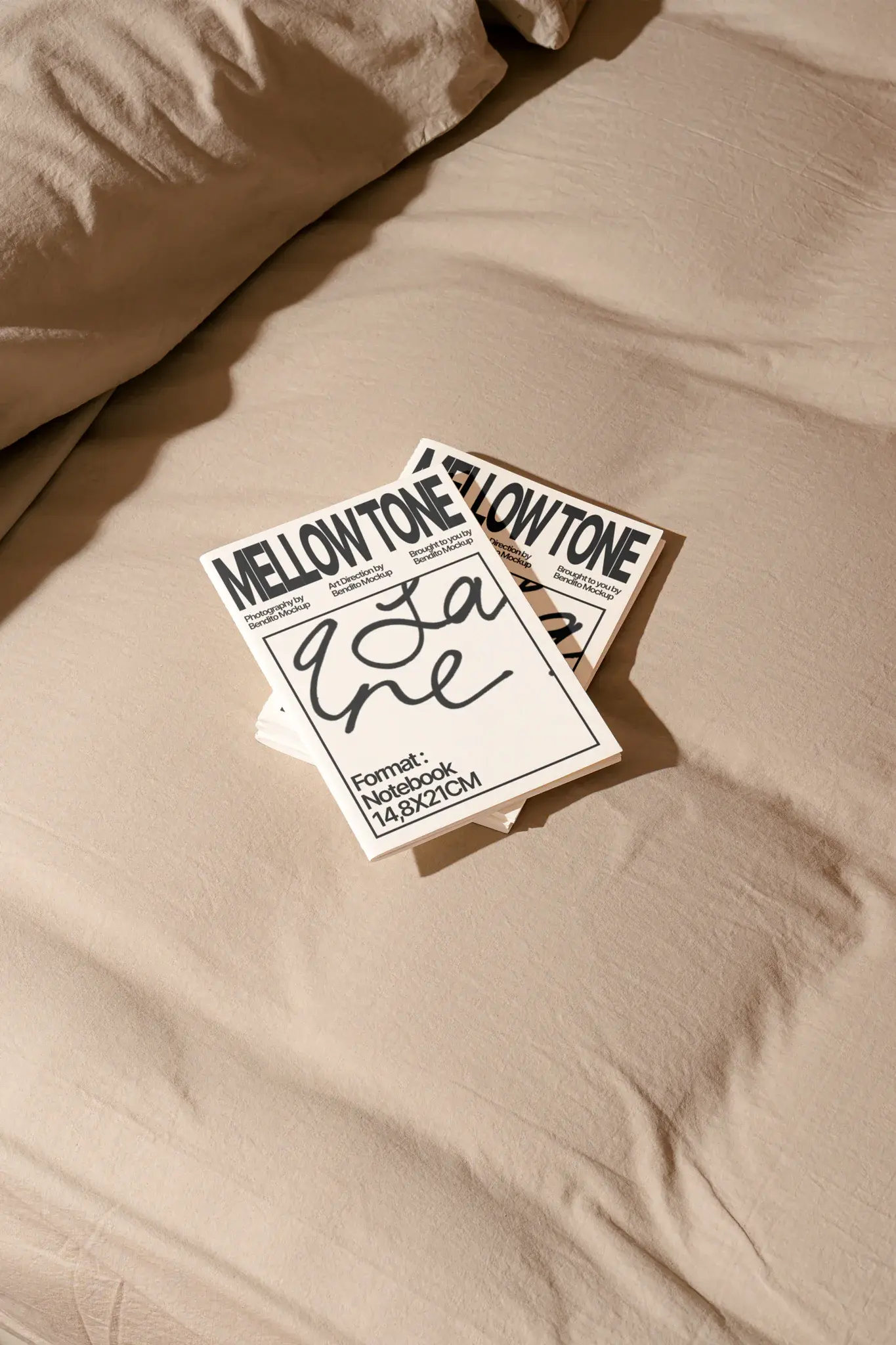 Sophisticated notebook mockup laying on top of a bed