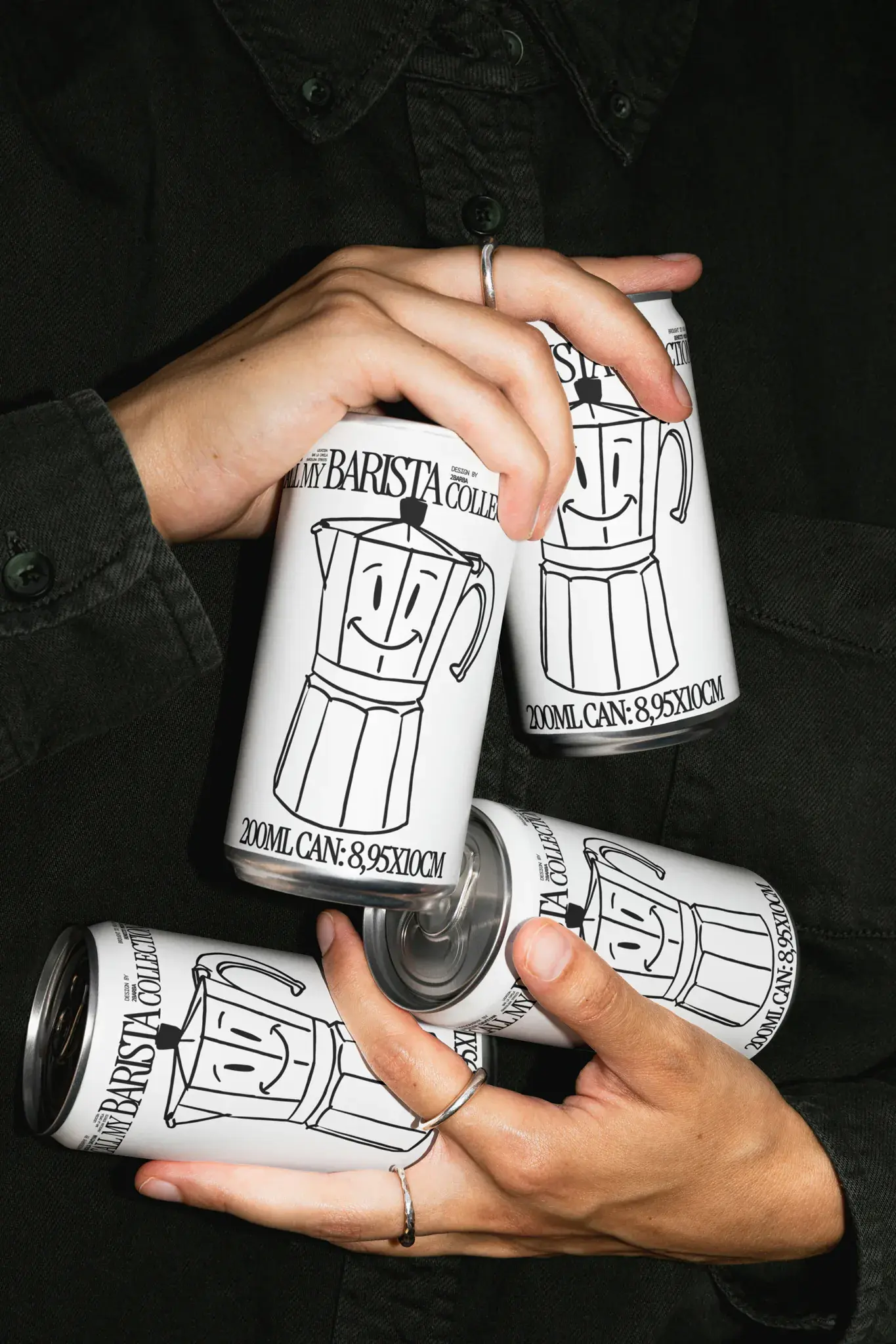 Pile of aluminum cans mockup being grabbed by human hands. PSD mockup file of a beer can, beverage can being sustained by a human wearing contemporary, black clothes. Packaging mockup, aluminum cans mockup.