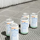 Aluminum can mockups laying on the street, urban scenario, modern style. Pack of aluminum can mockups on concrete surface. Beverage mockup, soft drink can mockup, label mockup, beer can mockup, packaging mockup, cold brew mockups, premium quality.