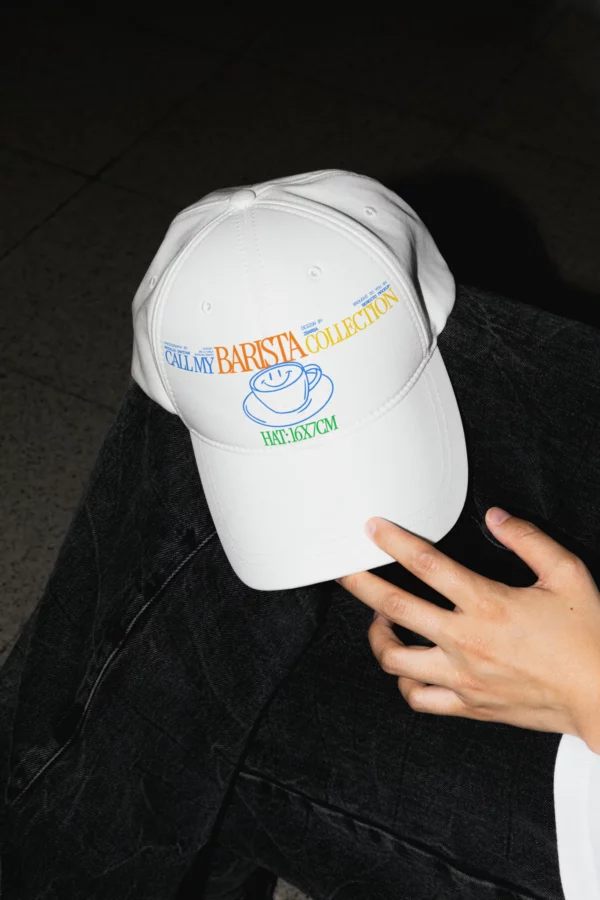 Cap mockup, baseball cap mockup, hand holding a cap mockup, hat mockup, beanie mockup, snapback mockup in a urban scenario, minimalist mockup, natural shadows, real photography, girl holding a cap mockup, PSD file, premium quality.