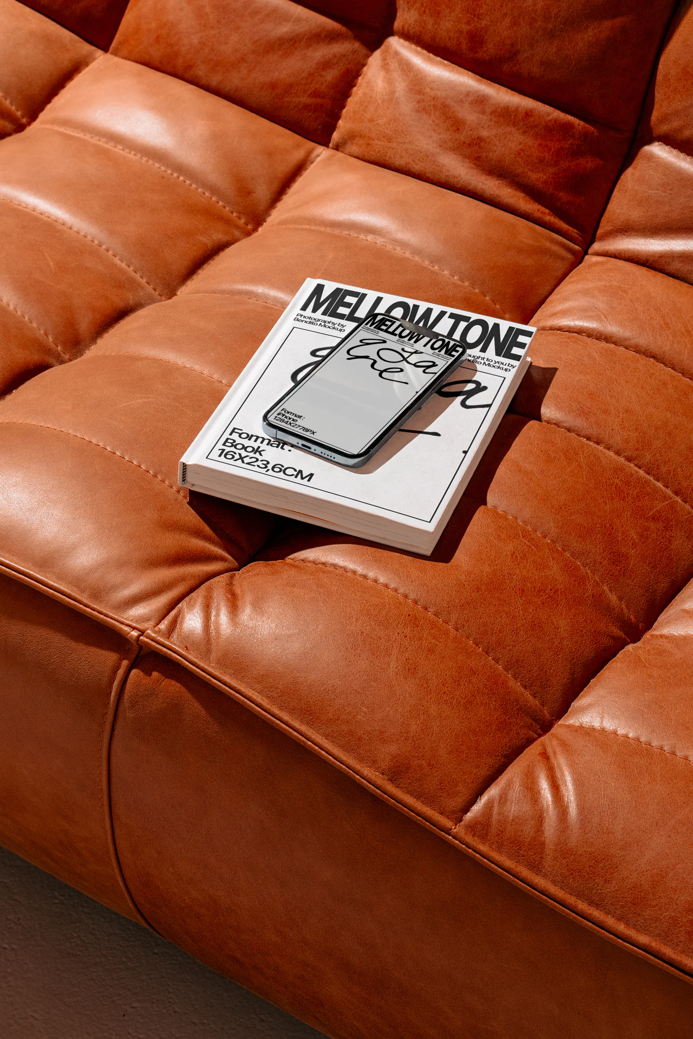 iPhone mockup on a brown sofa