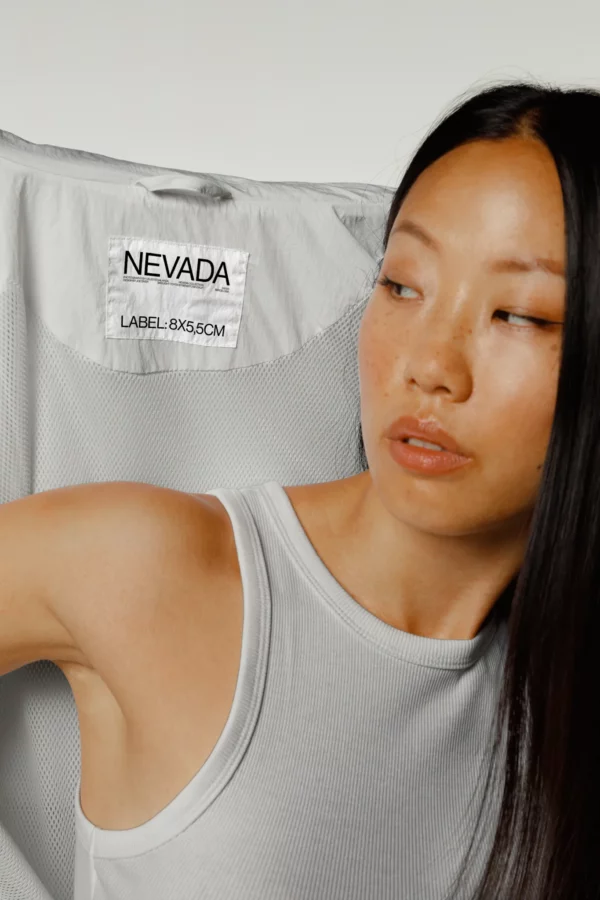 Asian female wearing a tank top mockup and a wind breaker mockup, label mockup, tank top mockup, PSD file of a woman wearing a wind breaker mockup, high quality mockup, PSD file, premium quality fashion mockup.