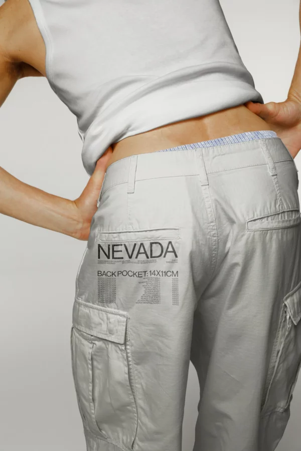 Guy on his back wearing a white pants mockup and white tank top mockup, pants pocket mockup, pocket mockup, PSD file, apparel mockup, clothing mockup, premium quality fashion mockup.