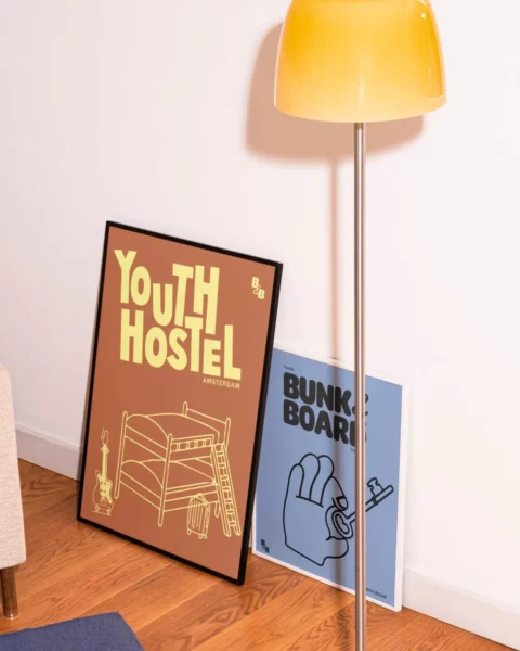 Two posters behind a lamp