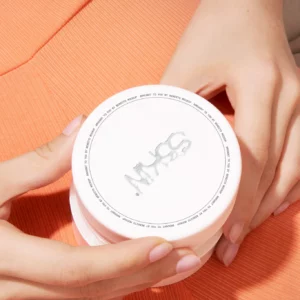 Woman with an orange dress holding a cosmetic jar mockup. Packaging PSD file. Cream jar mockup. Skin care mockup.