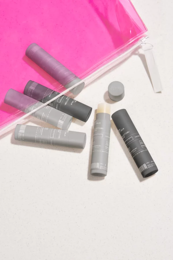 Set of lip balms mockup inside a pink transparent bag. Lip balm mockup. Cosmetic PSD file. High-quality lip balm mockup.