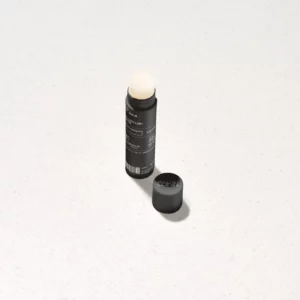 Lip balm mockup standing on a white surface. Lip balm mockup. Skin care PSD file. High-quality lip balm mockup.