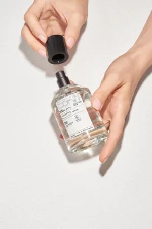 Woman opening a perfume bottle mockup. Perfume bottle mockup. Perfume bottle PSD file. High-quality packaging mockup.