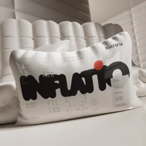 Neumatic pillow mockup in front of an off-white design neumatic couch in a room with off-white inflatable walls. Pillow mockup. Pillow PSD file. 3d mockup. Premium quality 3d mockup.