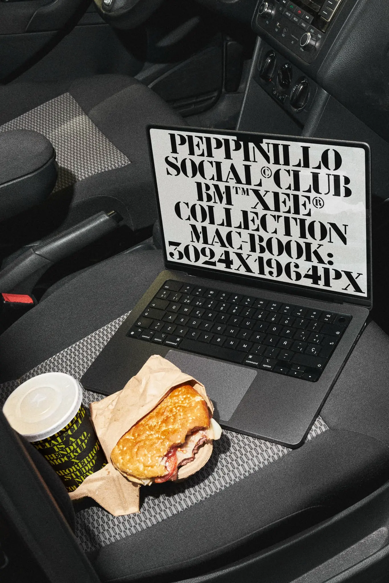 MacBook Pro mockup next to disposable paper cup mockup which is together with a burger on top of a dark seat of a car that is parked in the parking of a fast food restaurant. Device mockup. MacBook Pro PSD file. Packaging mockup. Takeaway mockup. Drink Mockup. Paper cup mockup. Fast food mockup. Premium quality paper cup mockup. MacBook Pro PSD high-quality editable file.