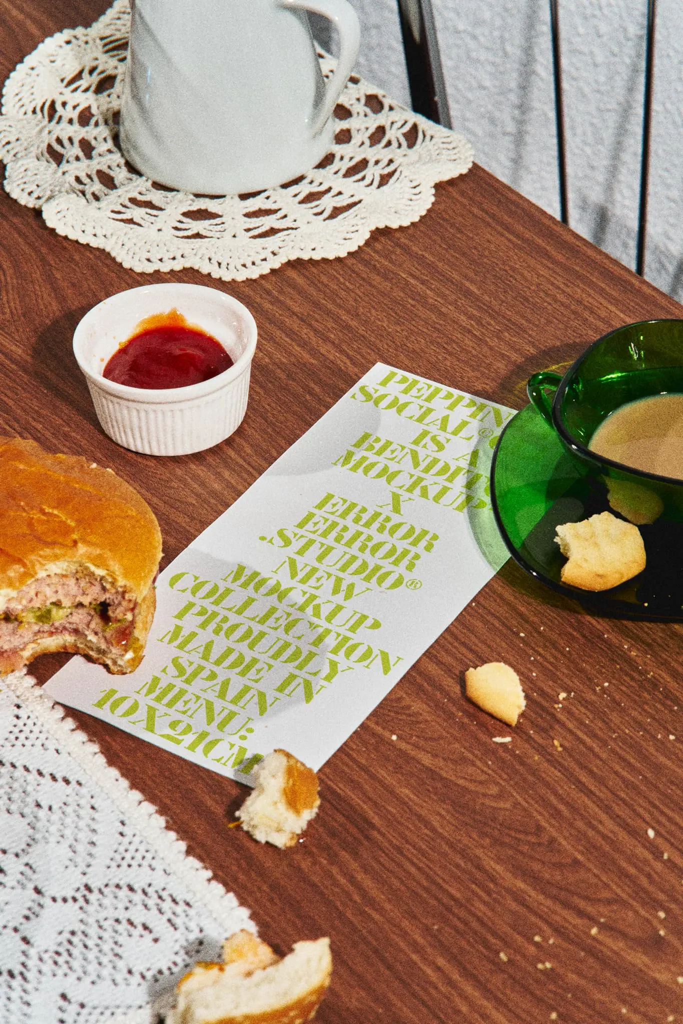 Menu mockup together with a half-eaten hamburger with crumbs, a cup of coffee, and ketchup on a burguer place wooden table with doilies. Takeaway mockup. Restaurant menu PSD file. Print mockup. Fast food mockup. High-quality menu mockup. Burger PSD high-quality editable file.