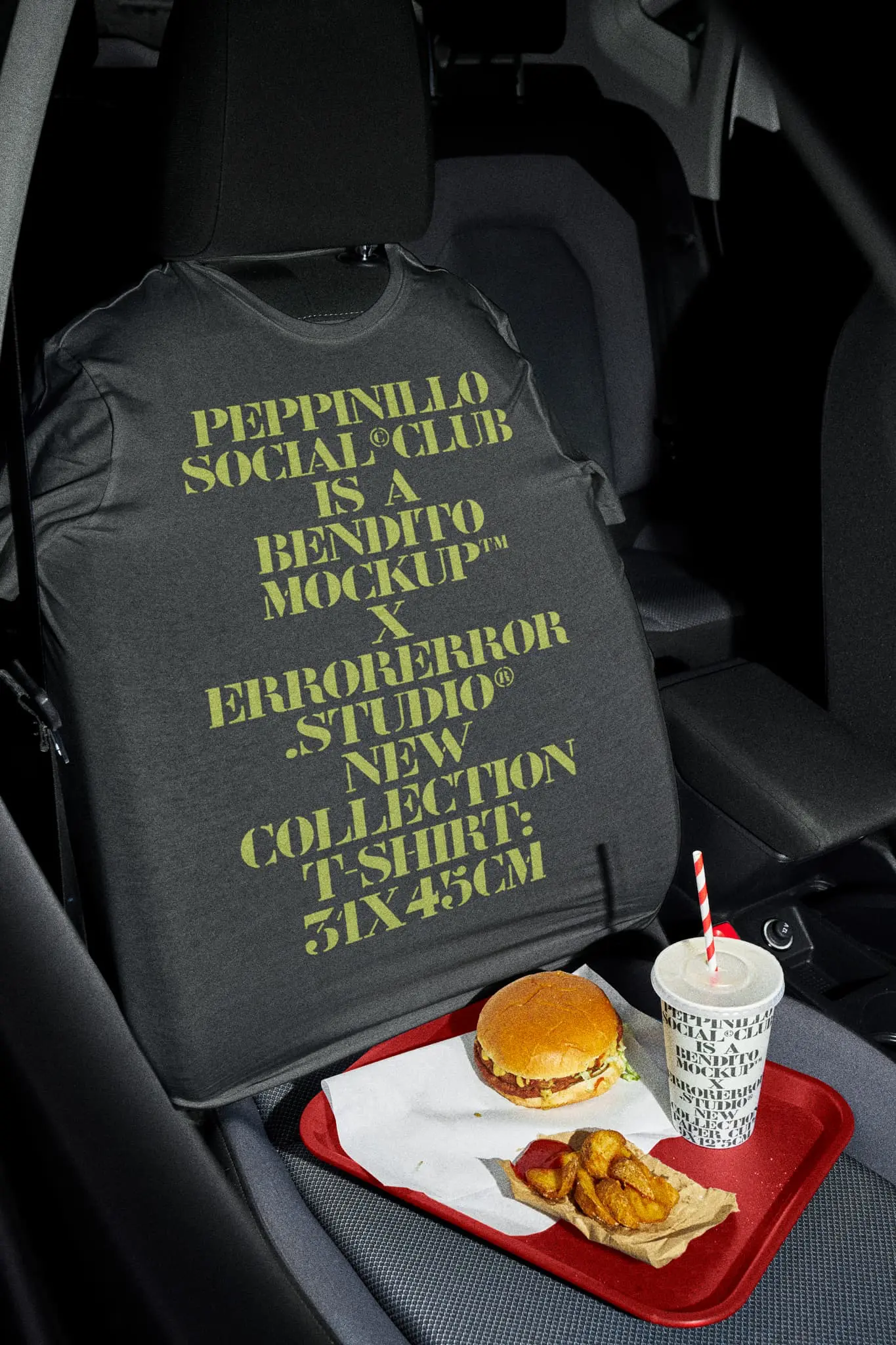 T-shirt mockup placed in the seat of a car that is in a take-away restaurant with a disposable paper cup mockup which is on a blue tray with a burger menu with fries on top of the car seat. Clothing mockup. Tee mockup. Takeaway PSD file. Takeaway mockup. Drink mockup. Paper cup mockup. Fast food mockup. Premium quality t-shirt mockup. Takeaway PSD high-quality editable file. Paper cup high-quality mockup.