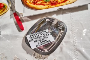 High quality business card mockup laying on metal tray on table next to pizza box. Premium business card mockup in pizza restaurant. Aesthetic business card mockup file for Adobe Photoshop.