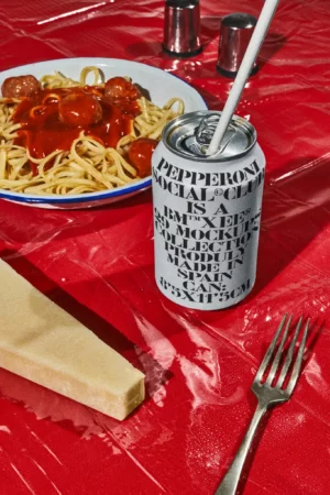 Aesthetic mockup of a soda tin can with a straw on a restaurant table. High quality editable can mockup ideal for your drink brand. Aluminium can mockup for all kinds of canned edible products in an editable file for Adobe Photoshop. Packaging mockup.