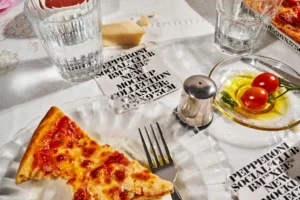 Aesthetic square card coaster mockups on a pizza restaurant table. Brand mockup. Premium mockups of paper square coasters in restaurant. Editable high quality PSD files for your brand. Packaging mockup.