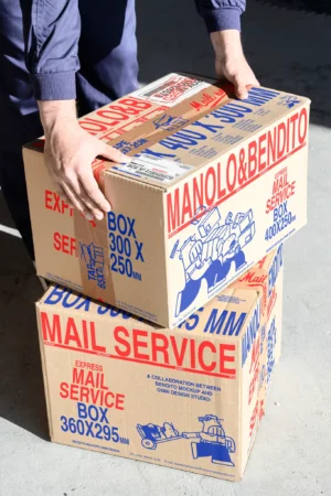 Aesthetic postage mockup of two boxes with editable tape and stickers to display your brand. High-quality mockup for your postal brand of two boxes being picked up by the mail man. Packaging PSD file. Box mockup. Premium box mockup created for Adobe Photoshop.