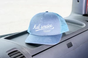 Aesthetic hat mockup placed inside a car on the dashboard. High-quality cap mockup for displaying your branding projects. Clothing mockup. Hat PSD file. Premium mockup created for Adobe Photoshop.