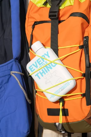 Memobottle 'Every Little Thing' mockup attached to a hiking backpack