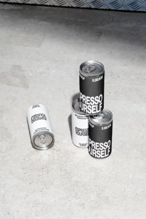 Espresso Yourself coffee cans on concrete floor