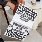 Person holding an unfolded Espresso Yourself newspaper mockup
