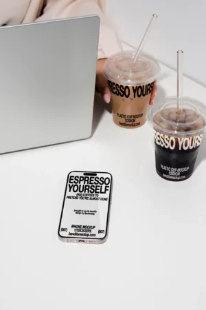Espresso Yourself iPhone case and coffee cups on a desk