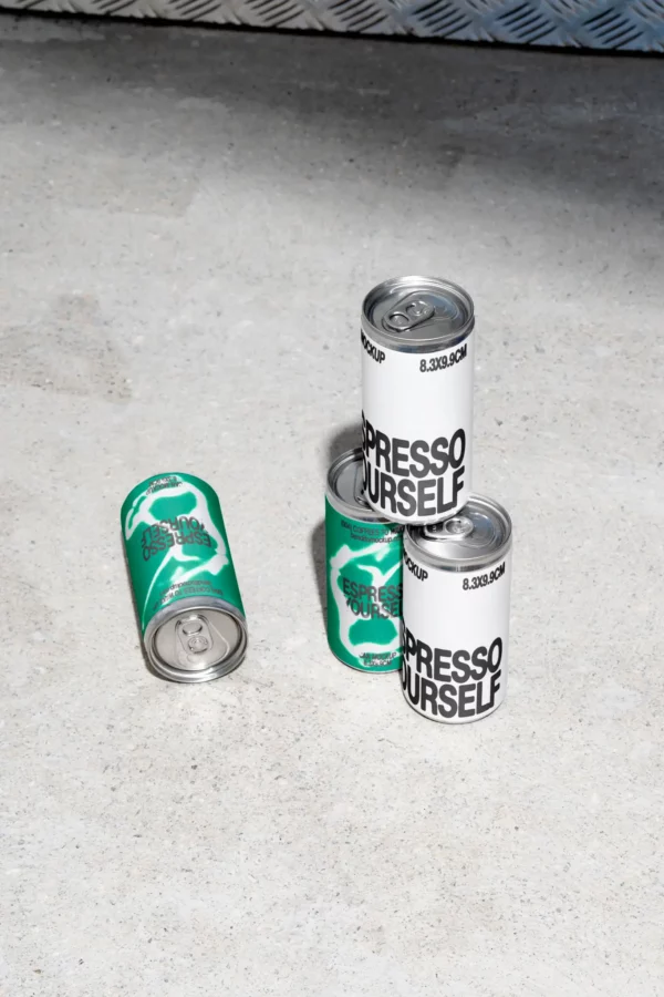 Color Version: Espresso Yourself coffee cans on concrete floor