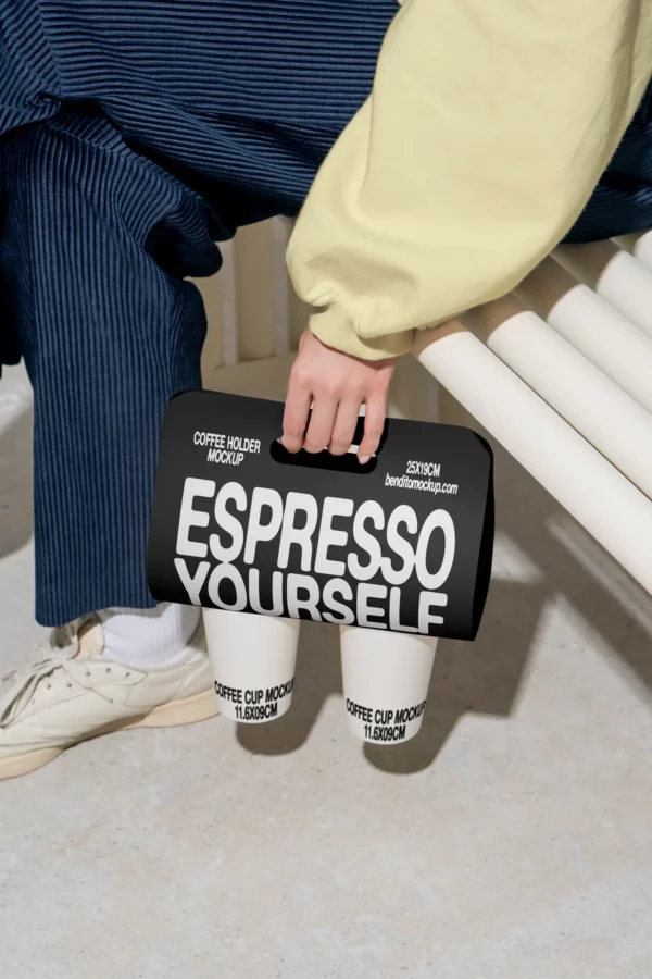 Color Version: Person holding a coffee holder with two Espresso Yourself coffee cups