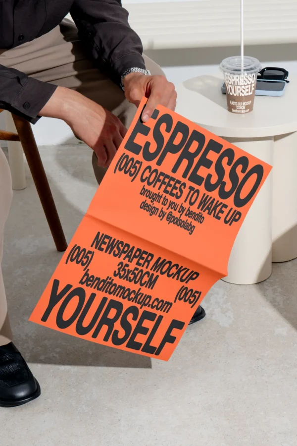 Color Version: Person holding an unfolded Espresso Yourself newspaper mockup