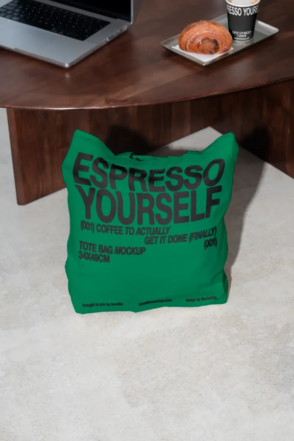 Color Version: Espresso Yourself tote bag mockup on the floor next to a coffee table