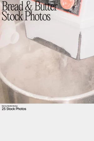 Close-up of a dough mixer in action with flour dust in the air, part of the Bread & Butter stock photo collection.