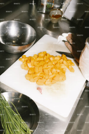 Diced vegetables on a cutting board in a kitchen.