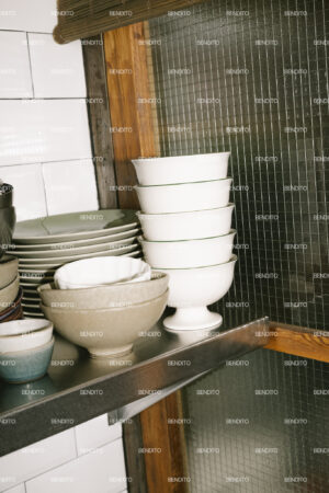 Stack of ceramic bowls in a rustic kitchen.