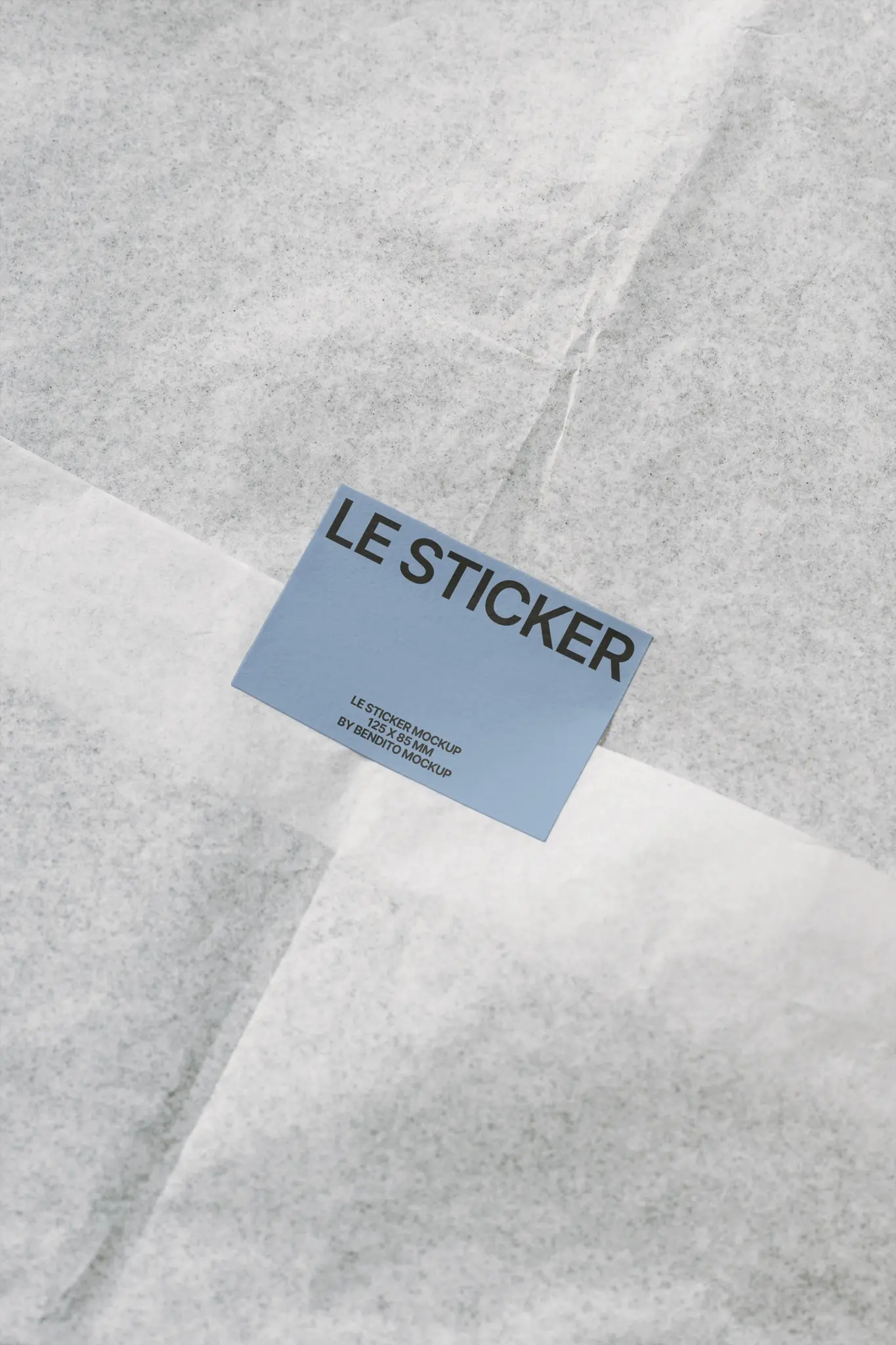 Blue rectangular sticker on white textured paper wrapping.