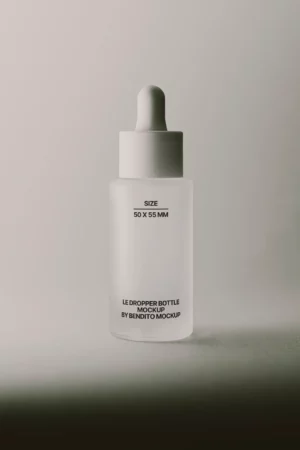 Clear glass bottle with a dropper on a white background.