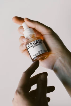 Mockup of a dropper bottle on a white surface.