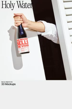 Mockup image of a hand holding a wine bottle with bold red typography that reads “This Mockup Sells the Vision,” emerging from behind white shutters into direct sunlight.